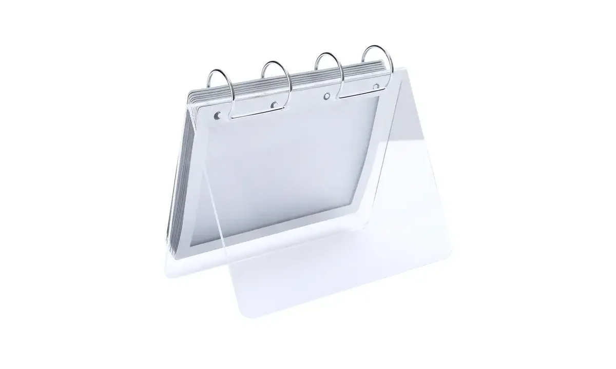 Clear angled desk calendar support with four metal rings and a stack of blank pages.
