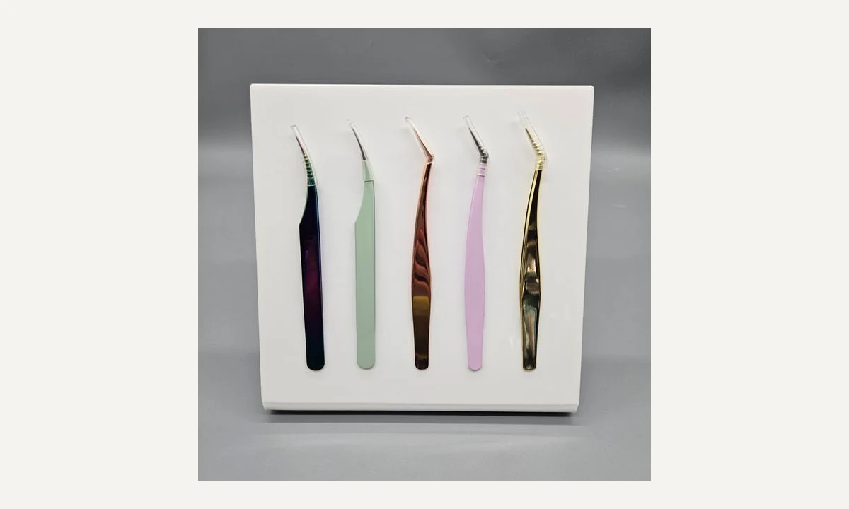 Open white upright magnetic stand displaying straight and angled coloured tweezers.