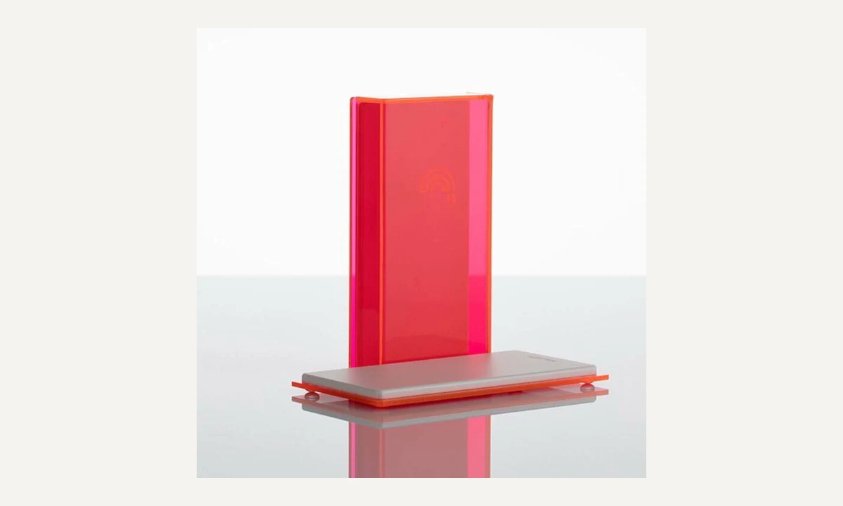 Red upright table-sign panel seated in a separate horizontal slotted base.