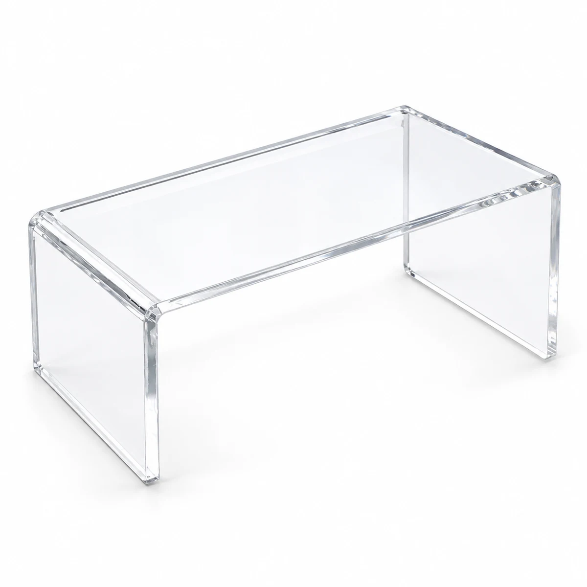Single clear acrylic bridge shelf with a flat rectangular top and two side supports, open at front and back