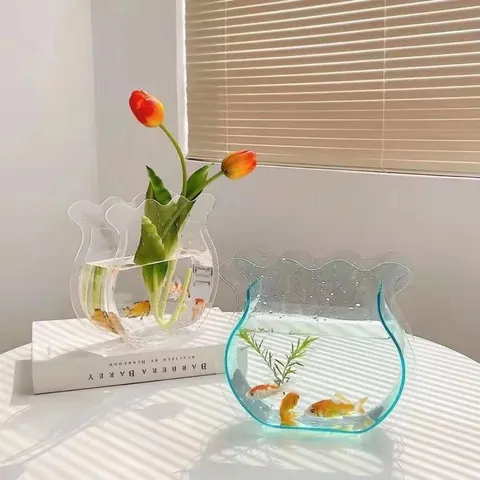 Transparent decorative fishbowl-shaped vase references beside tulips