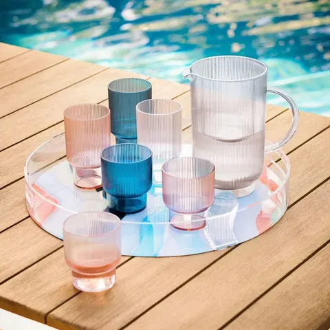 Round clear acrylic serving tray with a raised edge and personalized decoration