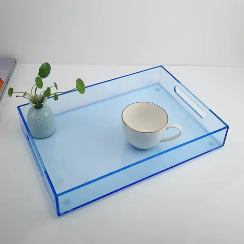 Colored rectangular acrylic serving tray with raised sides and handle openings