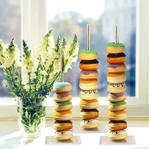 Three acrylic donut stands arranged at different heights
