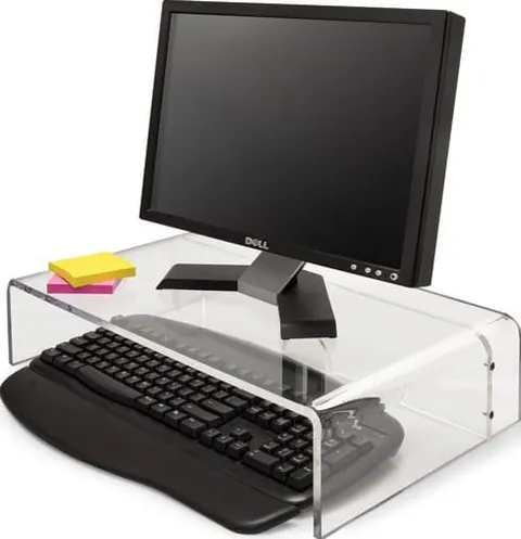 Clear bridge-style acrylic monitor riser above a desk surface