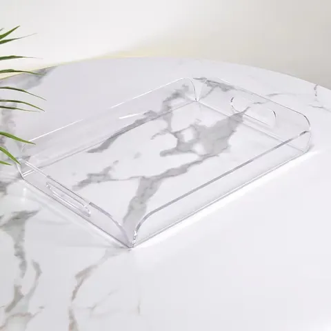 Clear acrylic serving tray with raised sides and handles