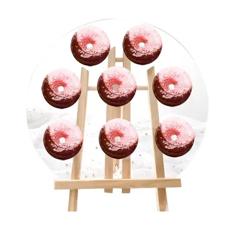 Upright wooden peg board displaying ring donuts in rows
