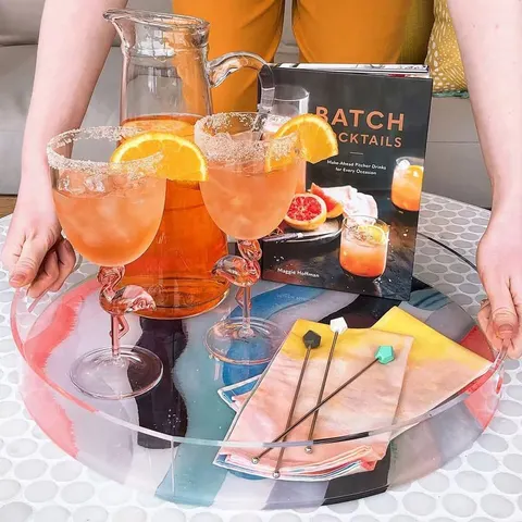 Round clear acrylic serving tray with a raised edge and personalized decoration