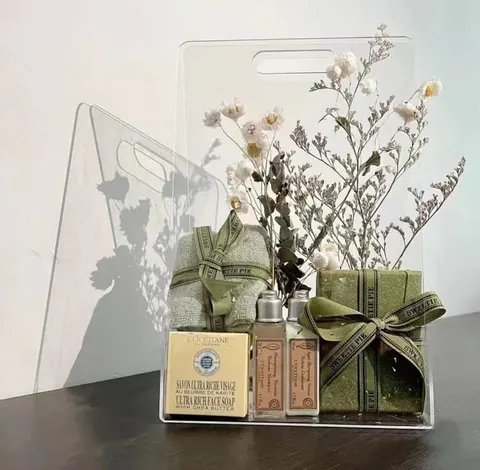 Open transparent gift-bag display with tall panels and cutout handles