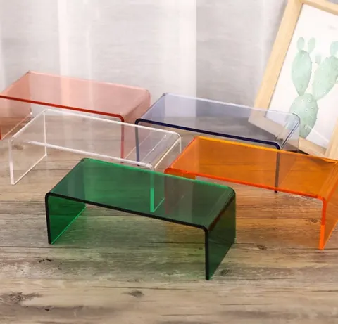Transparent colored acrylic risers in bridge and stepped display formats