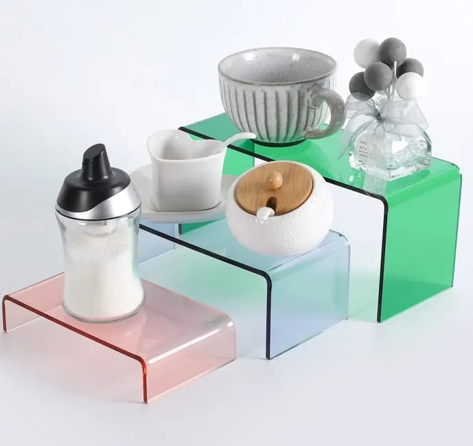 Transparent colored acrylic risers in bridge and stepped display formats