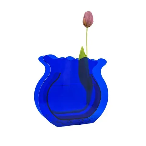 Blue fishbowl-shaped flower vase holding a single stem