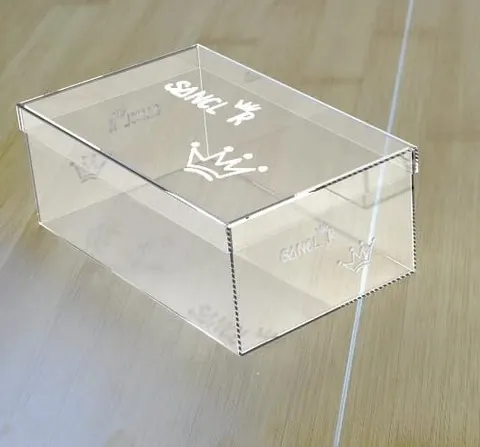 Clear acrylic shoe display box with a hinged opening