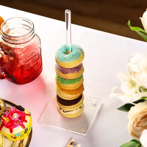 Single acrylic donut rod with a short stack beside a drink
