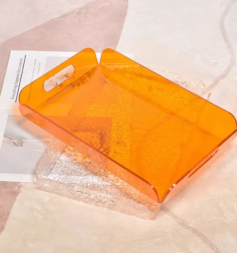 Orange acrylic serving tray with cutout handle openings