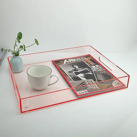 Colored rectangular acrylic serving tray with raised sides and handle openings