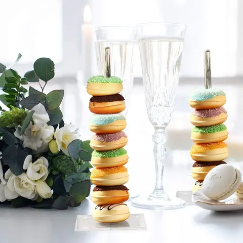Two upright donut display rods with clear square bases