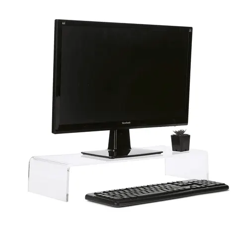 Clear bridge-style acrylic monitor riser above a desk surface