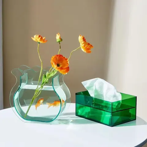 Shallow fishbowl-shaped vase with flowers on a tabletop